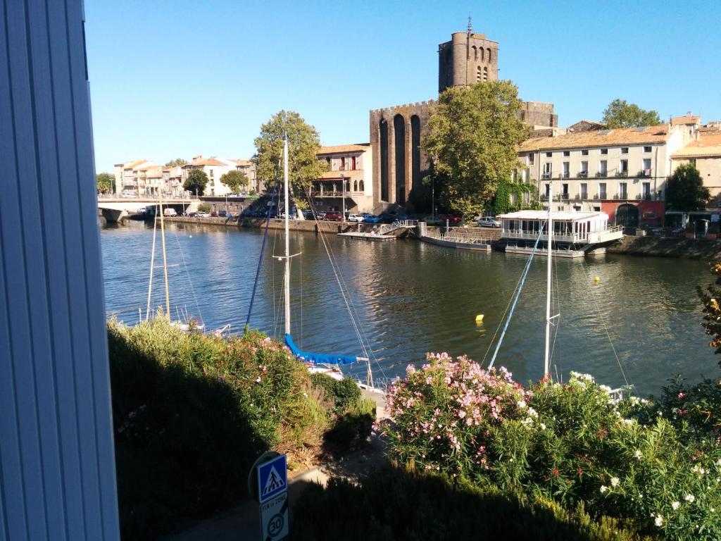 a view of a river with boats in it at Hotel Araur in Agde