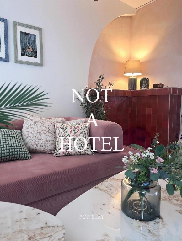 a living room with a couch with a not hotel sign at Jeonpo Cafe Street Near Seomyeon Entire House 2 Floors 7 Guests in Busan