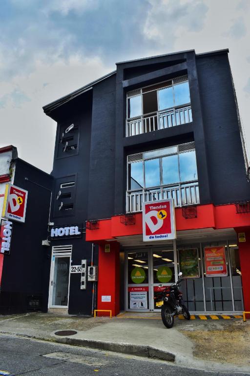 a black building with a motorcycle parked in front of it at DAM Hotel Pereira in Pereira
