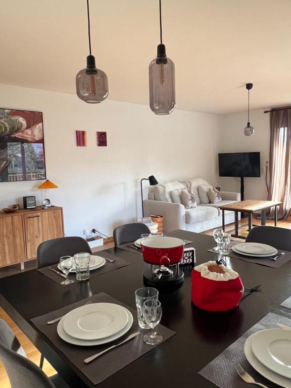a living room with a dining room table with chairs at Apartment with a garden, close to golf in Lens