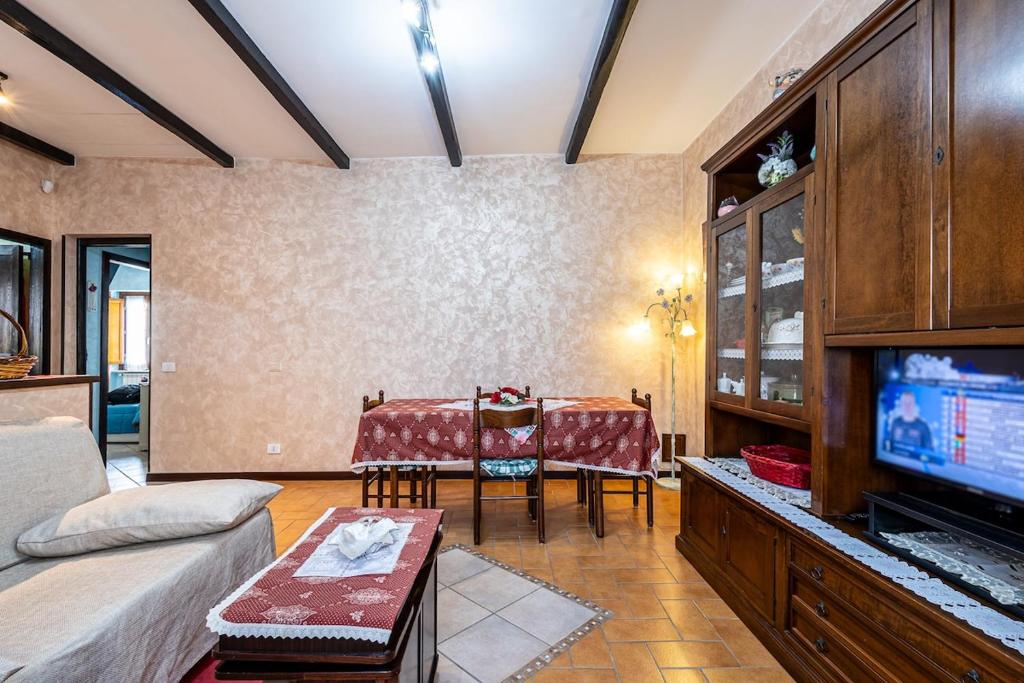 a living room with a table and a television at Maison de Marino - B&Brother's rome in Marino