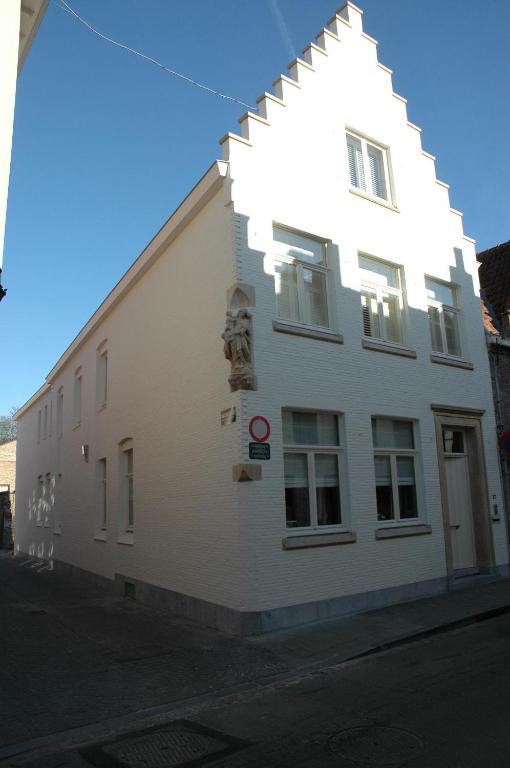 a white building with a geometric design on the side of it at La Luna Guesthouse in Bruges