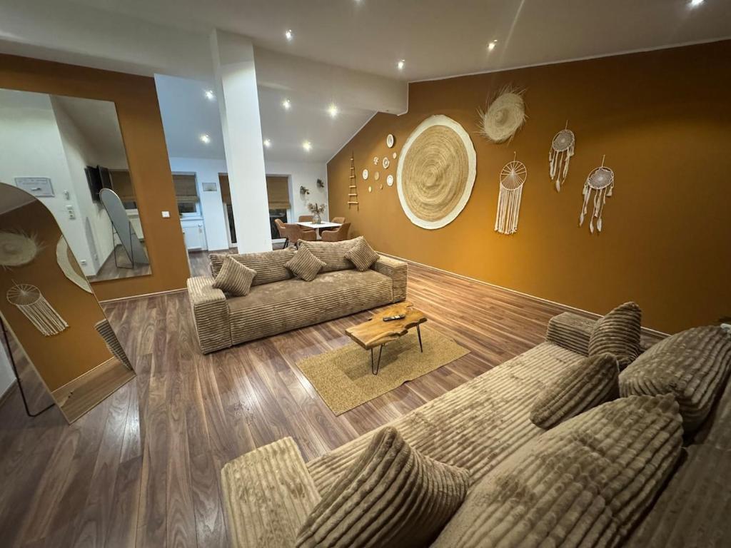 a living room with a couch and a table at BOHO Suite Tierra nähe Salzburg in Freilassing