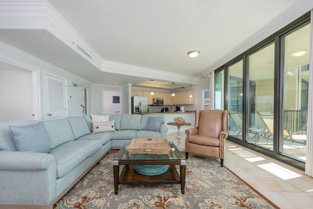 a living room with a blue couch and a table at Phoenix on the Bay 1320 in Orange Beach