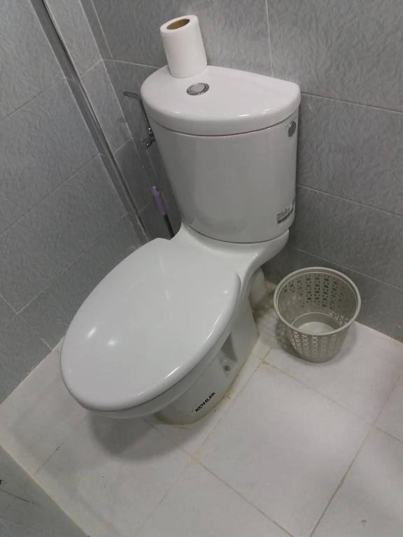 a toilet with a roll of toilet paper on top of it at La Chambre d hote in Ouarzazate
