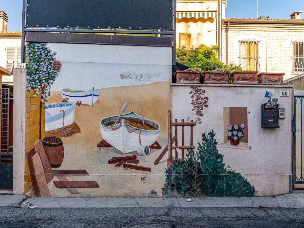 a mural on the side of a building at Lo Squero Guest House in Fano