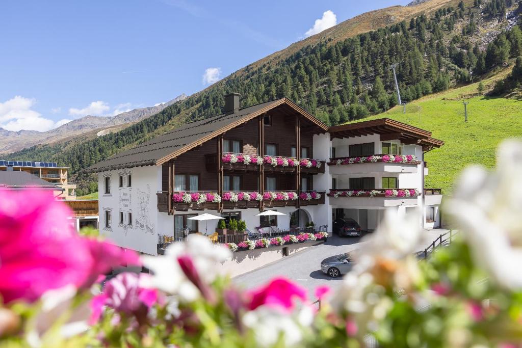 a large building with flowers in front of it at Haus Verwall in Obergurgl