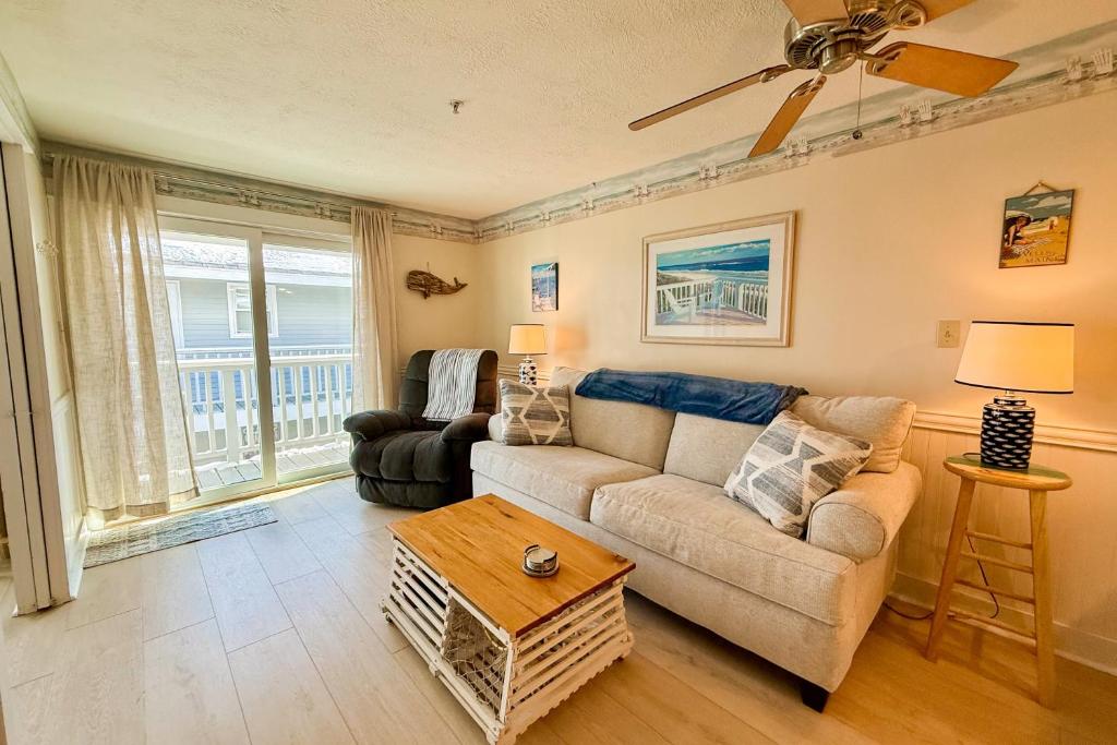a living room with a couch and a table at Saltwater Breeze in Wells