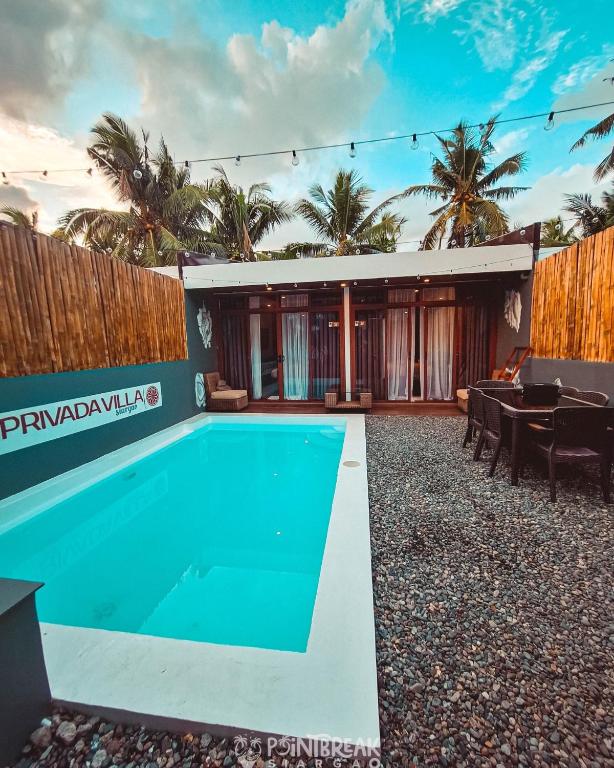 a swimming pool in the backyard of a house at Privada Villa Siargao in General Luna