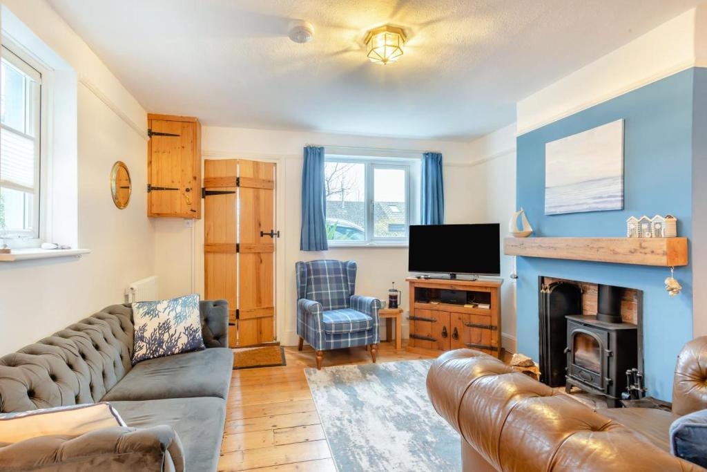 a living room with a couch and a television at 3 Bed in Kessingland oc-b27635 in Kessingland