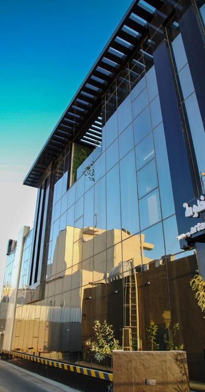 a building with a reflection of a building at ارتاما بوتيك للشقق المخدومة in Riyadh