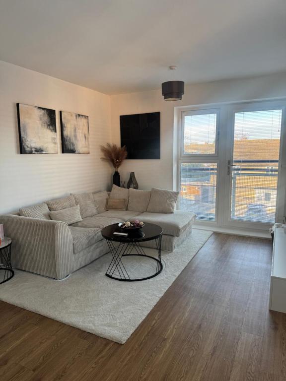 a living room with a couch and a table at 2 Bed apartment- Laindon in Great Burstead