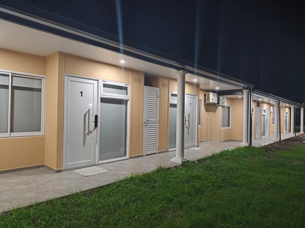 a row of doors on a building at night at Dormis del Sol in Caseros