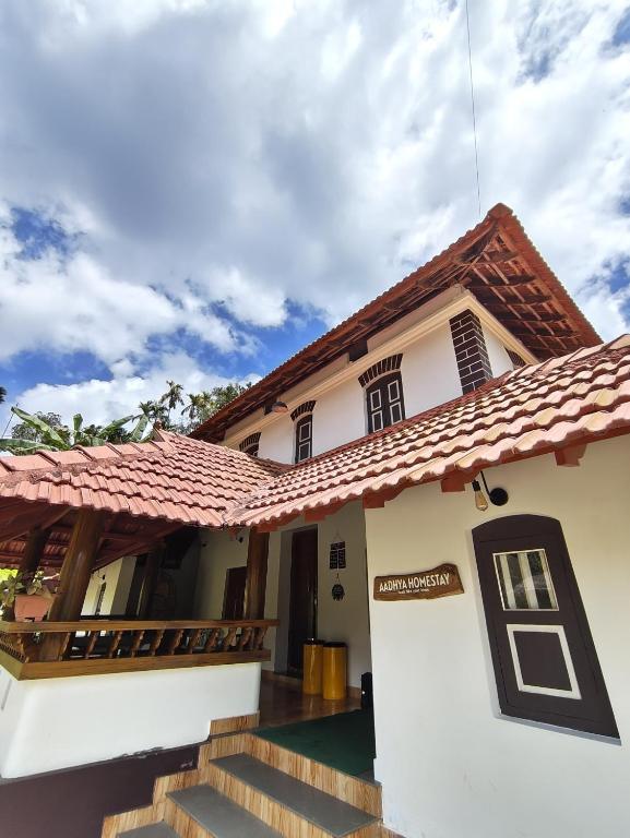 a house with a red roof at Aadhya Homestay 4BHK in Wayanad