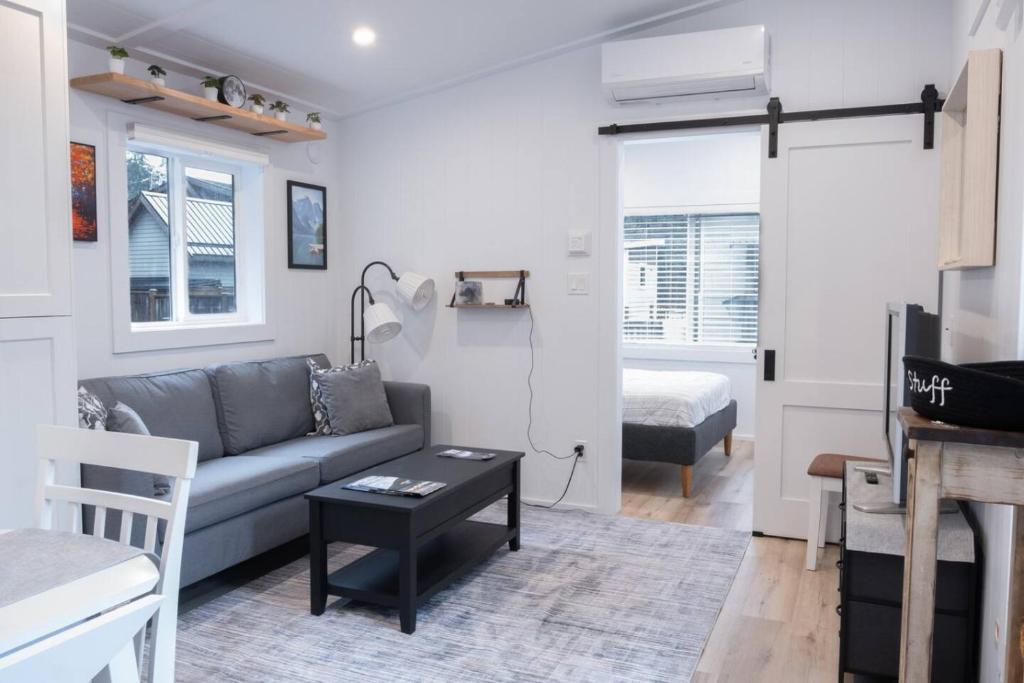 a living room with a couch and a table at Cozy 2 Bedroom Cabin in Sunshine Valley