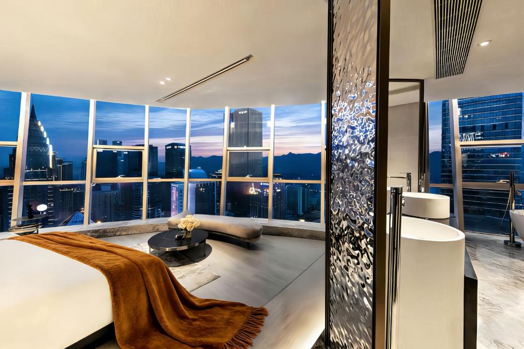 a bedroom with a view of a city skyline at Chongqing IBESHO HOTEL in Chongqing