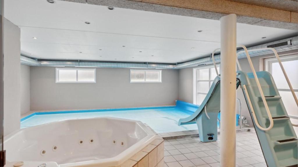a swimming pool with a tub and a slide at Villavilla 148 - Ebeltoft, Østjylland in Ebeltoft