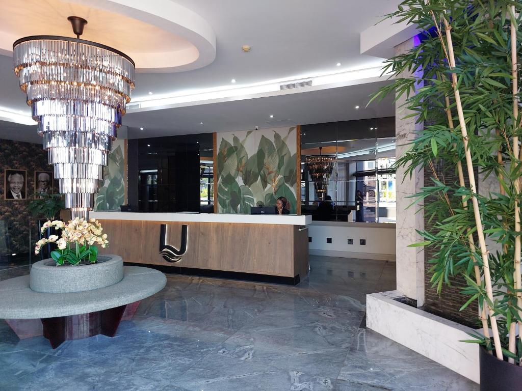 a lobby of a store with a large chandelier at Umhlanga Apart Hotel in Durban