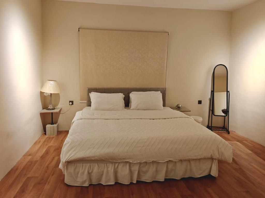 a bedroom with a large bed with white sheets at NOVA Homes in Medina