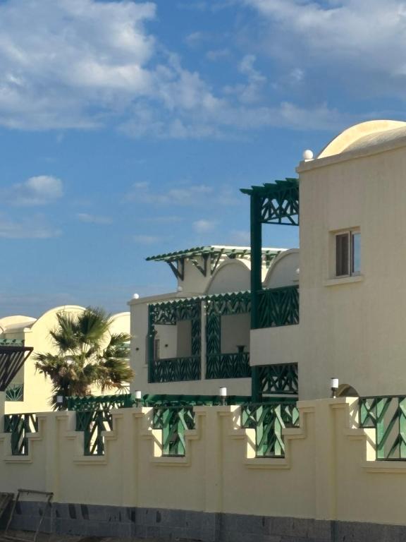 a building with a balcony on the side of it at Mazari in Marsa Alam City