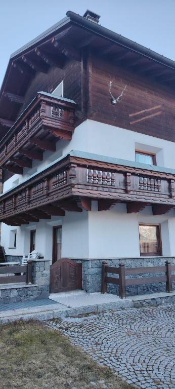 a building with wooden balconies on the side of it at La Dimora della Quiete in Valdidentro