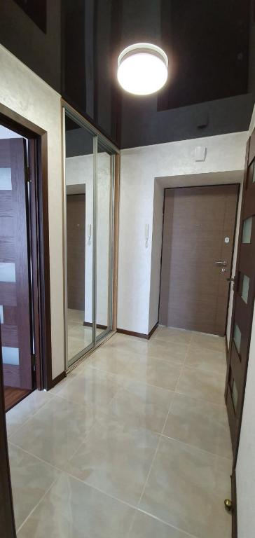 an empty room with two doors and a light at Панорама Апарт готель in Ternopil