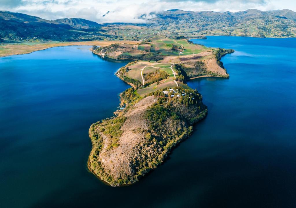 an island in the middle of a body of water at Entre Islas LODGE in Aquitania
