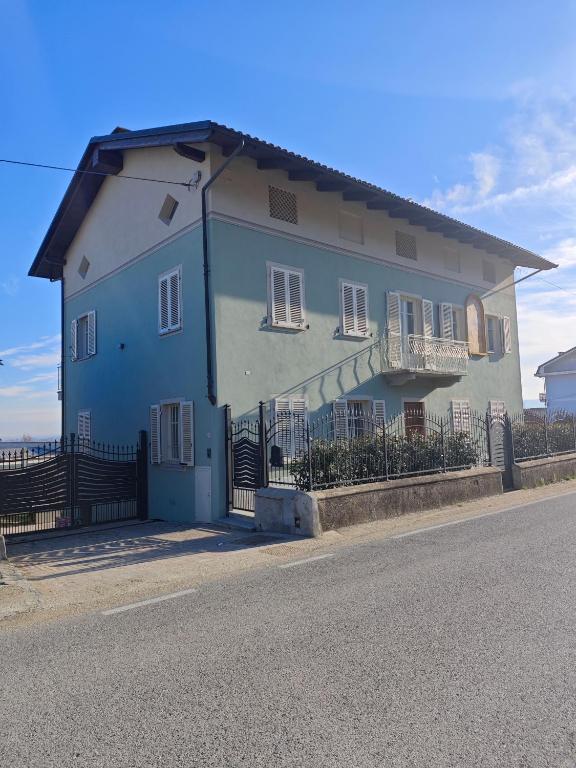 a blue house on the side of the street at B&B Da Cavalot in Envie