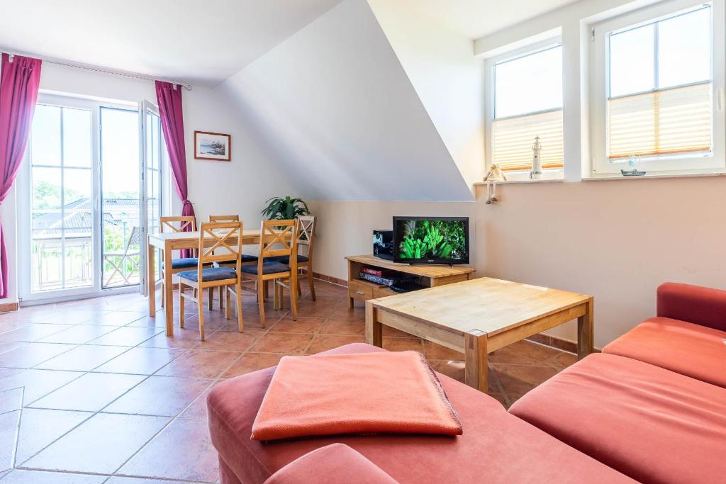 a living room with a couch and a table at Ferienwohnung Katharina OG in Wohlenberg