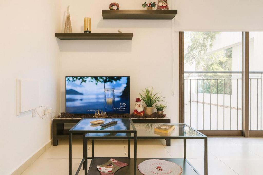 a living room with a tv and a glass table at Old town studio in Limassol