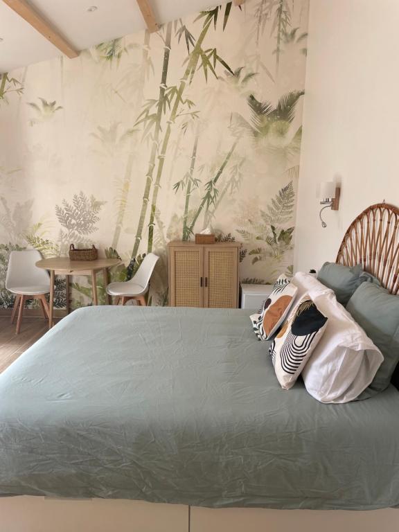 une chambre avec un lit et une table avec des chaises dans l'établissement L annexe, à Fouras