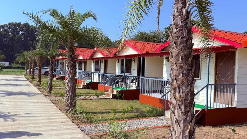 a row of houses with red roofs and palm trees at Tiger Woods in Jamania
