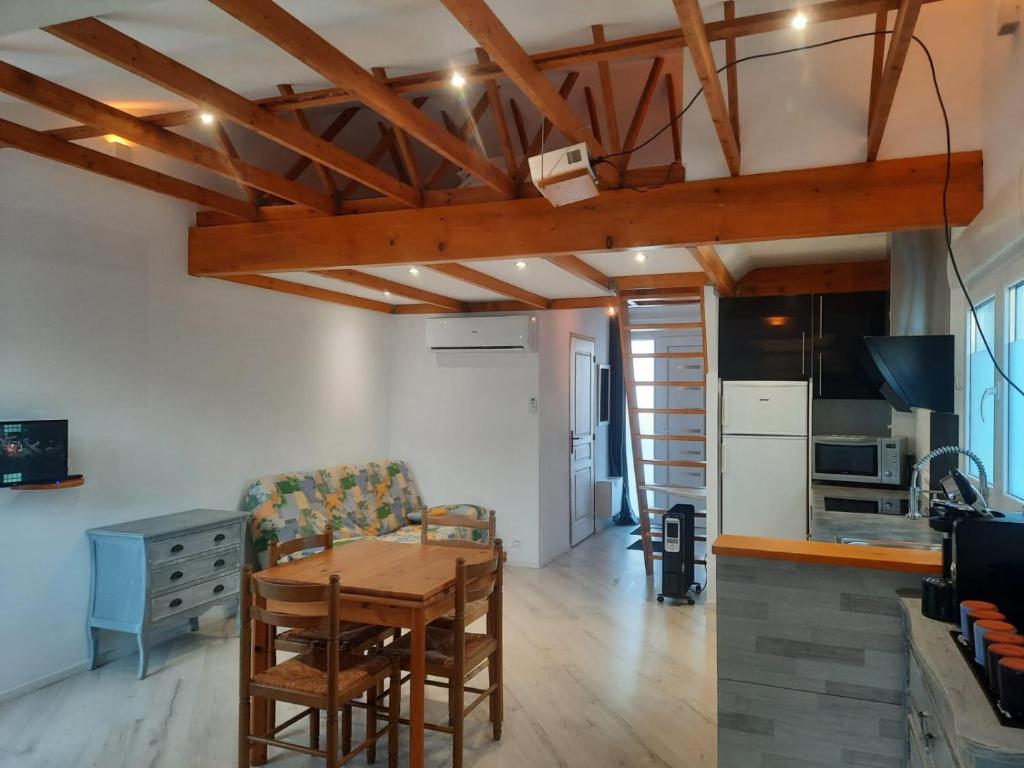 a kitchen and dining room with a table and chairs at L'Abri Côtier 2 in Les Sables-d'Olonne