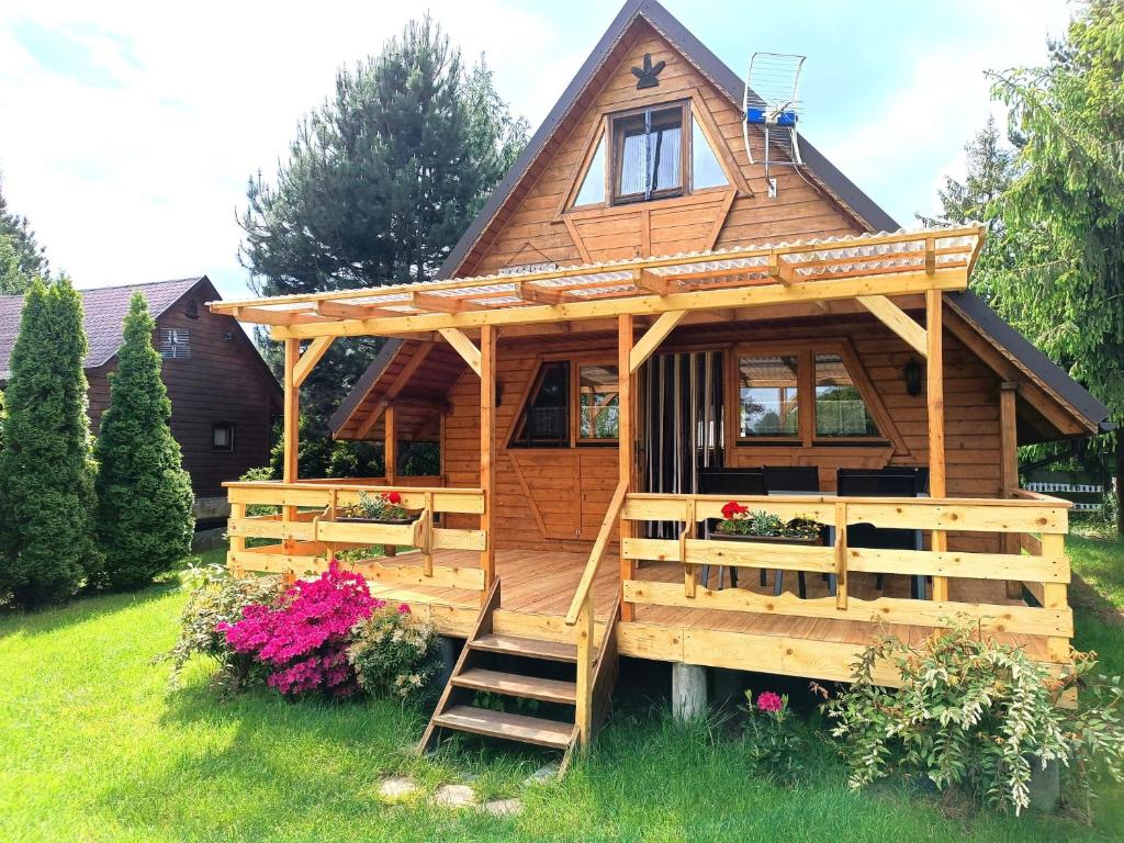 a log cabin with a staircase leading up to it at Domek Hanka in Biskupice