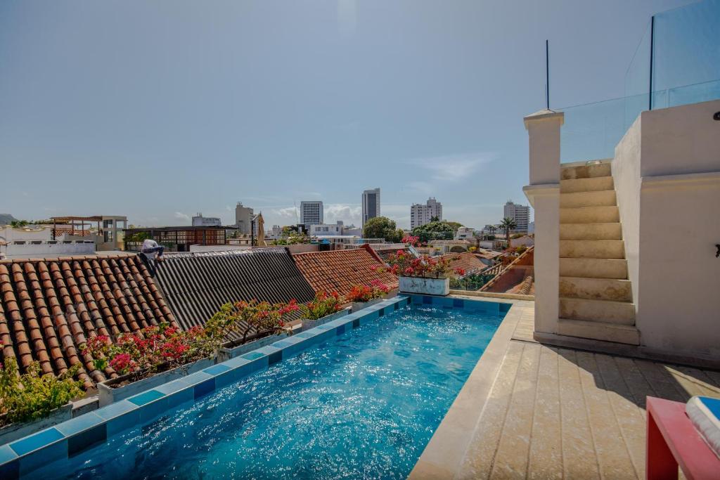 a swimming pool on the roof of a building at Casa Stella - Authentic Luxury Rooftop Pool in Cartagena de Indias