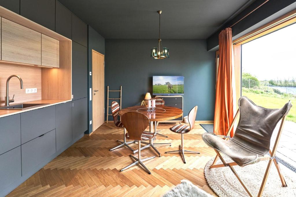 a kitchen with a table and chairs in a room at IDAHO - Deep in Süderstapel