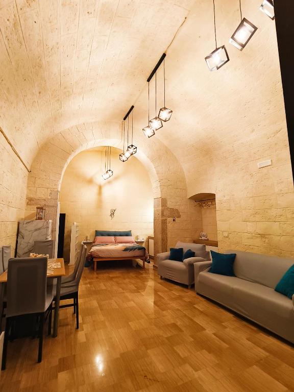 a living room with a couch and a table at Dimora Pietra e Mare Trani in Trani