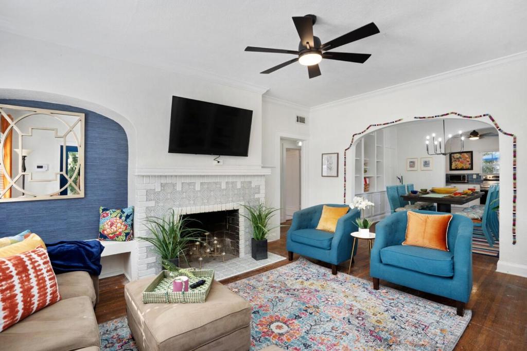 a living room with blue chairs and a mirror at Cruise the waterways from your backyard in Bradenton