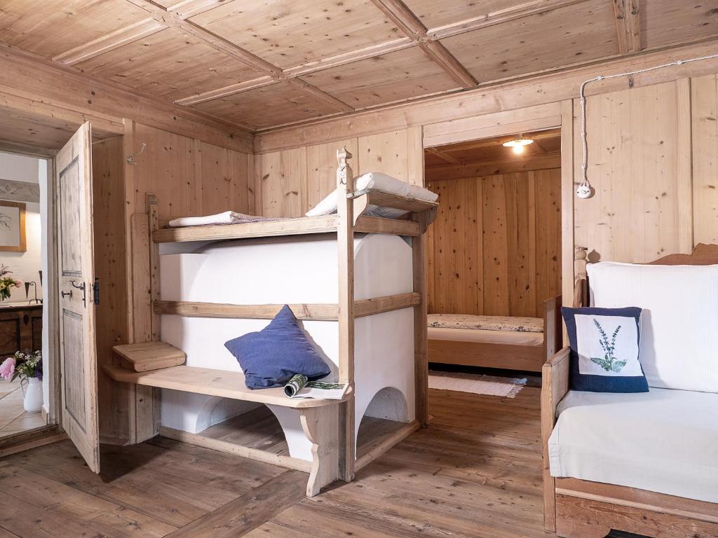 a bedroom with bunk beds in a wooden room at Landhaus Strickenmacher in Sillian
