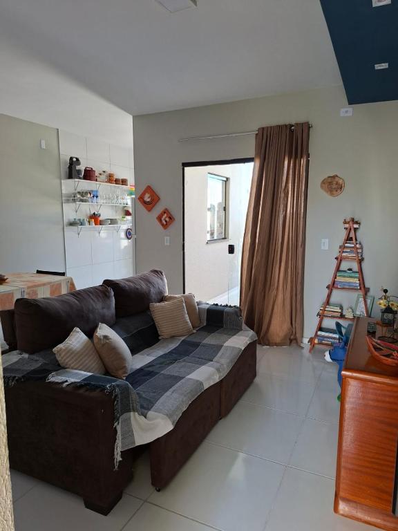 a living room with a brown couch in a room at Comfort right on the sand! in Paracuru