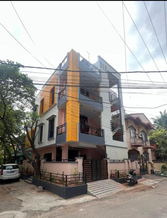 a building with a yellow and white at The 9th Oasis in Hyderabad