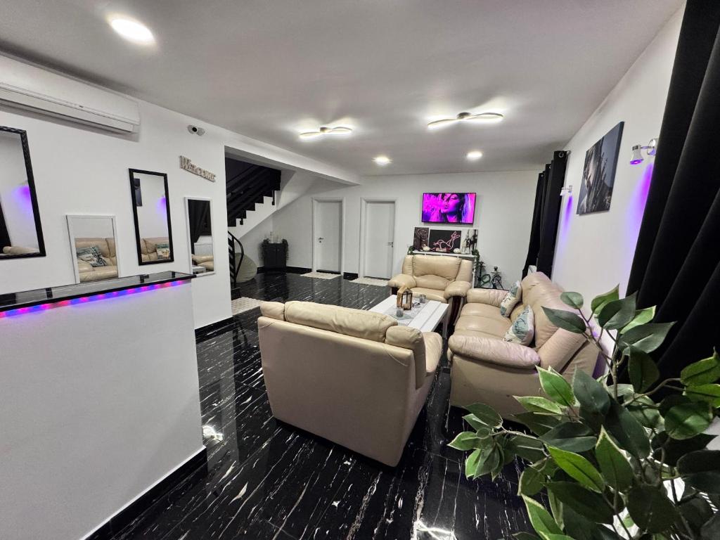 a living room with couches and a tv at Enjoy VIP House 10 in Măgurele
