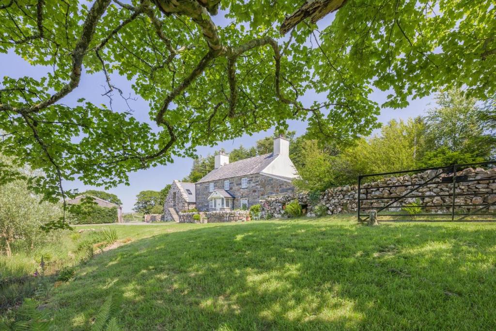 an old stone house with a gate in the yard at 4 Bed in Arthog oc-b31966 in Arthog