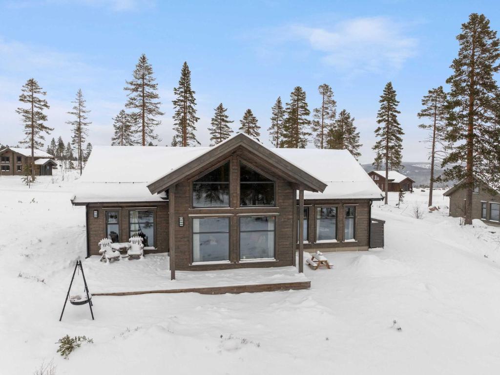 a small cabin in the snow with snow covered trees at TH2124- Spacious ski-in out cabin in Trysilfjell with 5 bedrooms in Hovi