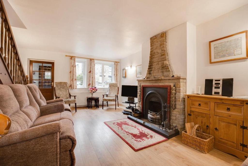 a living room with a couch and a fireplace at 3 Bed in Leyburn oc-ds013 in West Witton