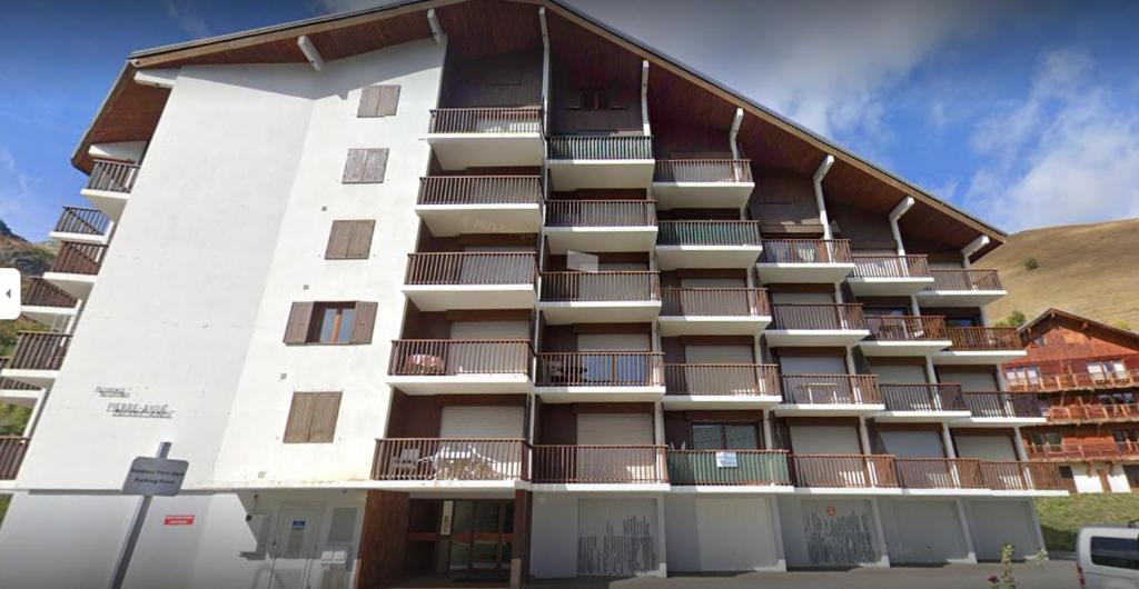 a large white building with balconies on it at Résidence Pierre Aiguë in Saint-Sorlin-dʼArves