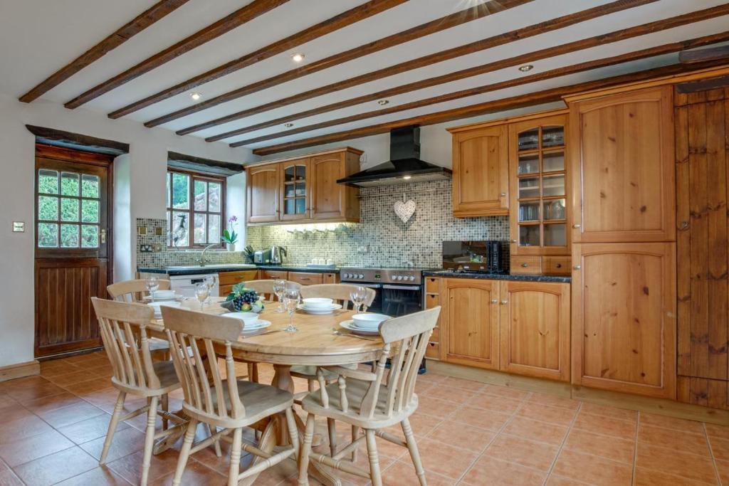 a kitchen with a wooden table and chairs at 2 Bed in Exminster oc-h28725 in Exminster