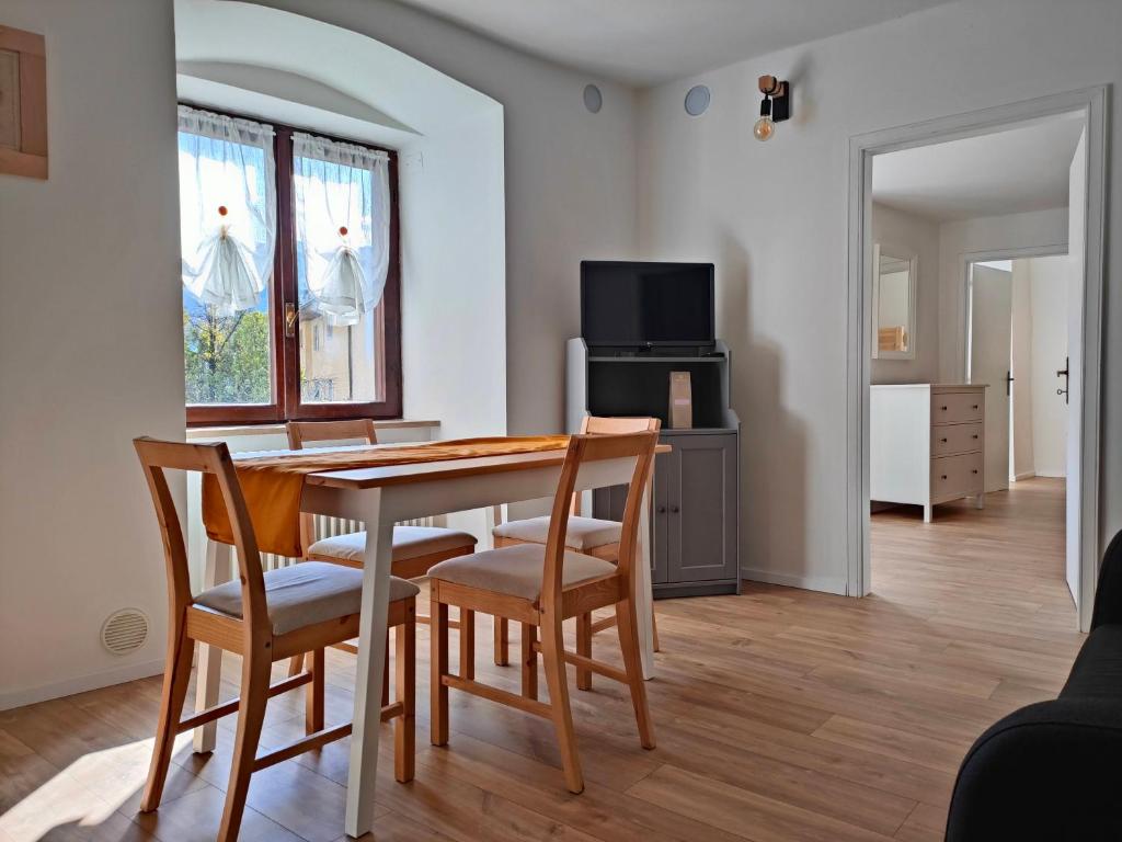 a dining room with a wooden table and chairs at in Piazza in Mezzocorona