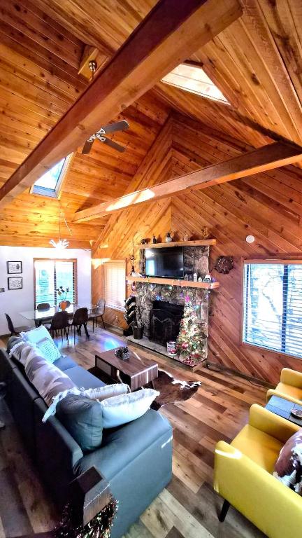 a living room with a blue couch and a fireplace at Guys Getaway Cabin in Ruidoso