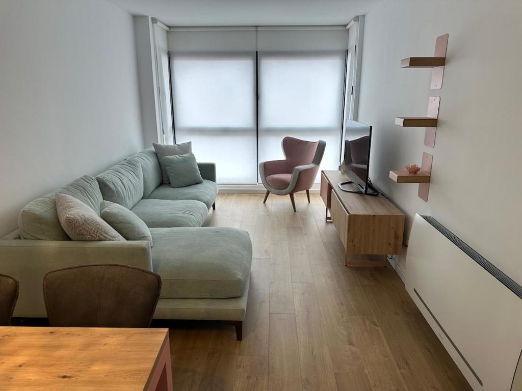 a living room with a couch and a television at 60m2 Cozy Apartament in Valencia